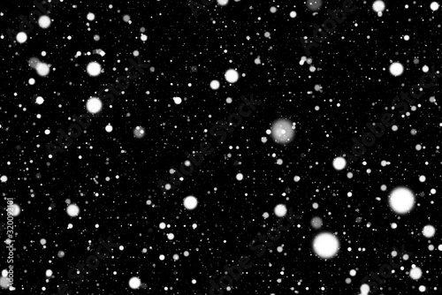 Fotografi Real bright white snow falls against the black background