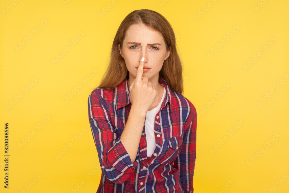 You lie! Portrait of upset ginger girl in checkered shirt pointing at nose, showing liar gesture and looking dissatisfied, blaming for falsehood, cheat. studio shot isolated on yellow background You lie! Portrait of upset ginger girl in checkered shirt pointing at nose, showing liar gesture and looking dissatisfied, blaming for falsehood, cheat. studio shot isolated on yellow background