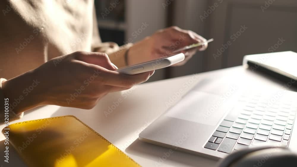Online banking with smart phone. Lifestyle. Easy pay using smart phone or digital device. Communication via app for sale in shop. Woman shopping online on a sunny day with credit card. Hands close up
