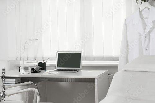 Doctor's workplace near window in medical office © New Africa