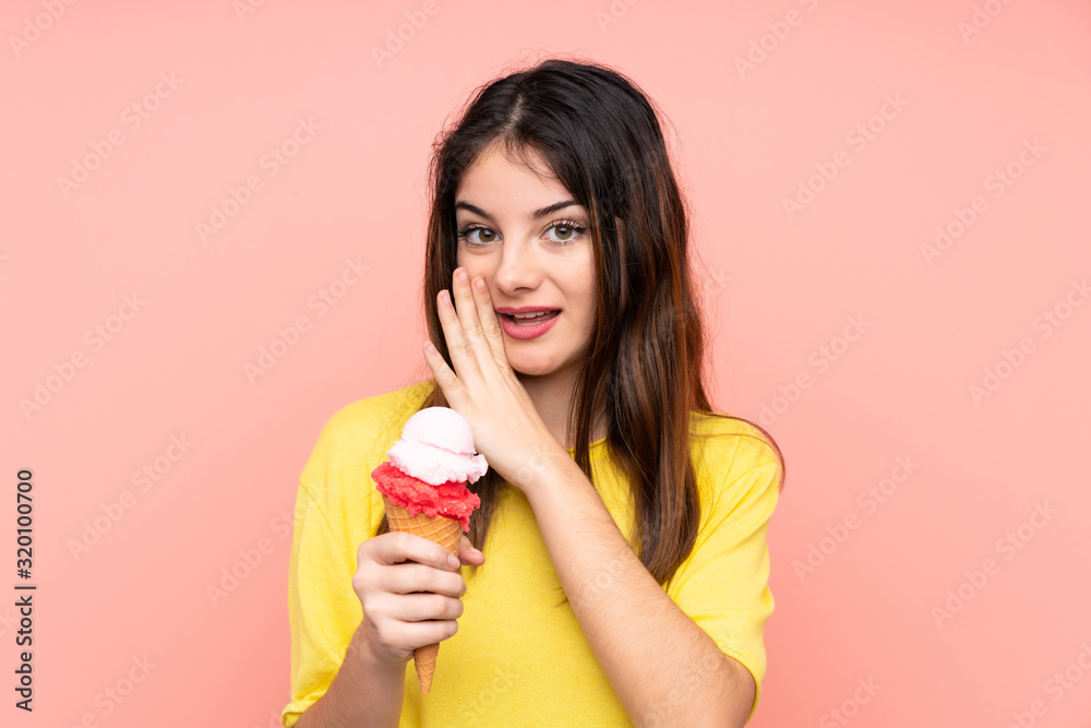 Young brunette woman holding a cornet ice cream over isolated pink background whispering something Young brunette woman holding a cornet ice cream over isolated pink background whispering something