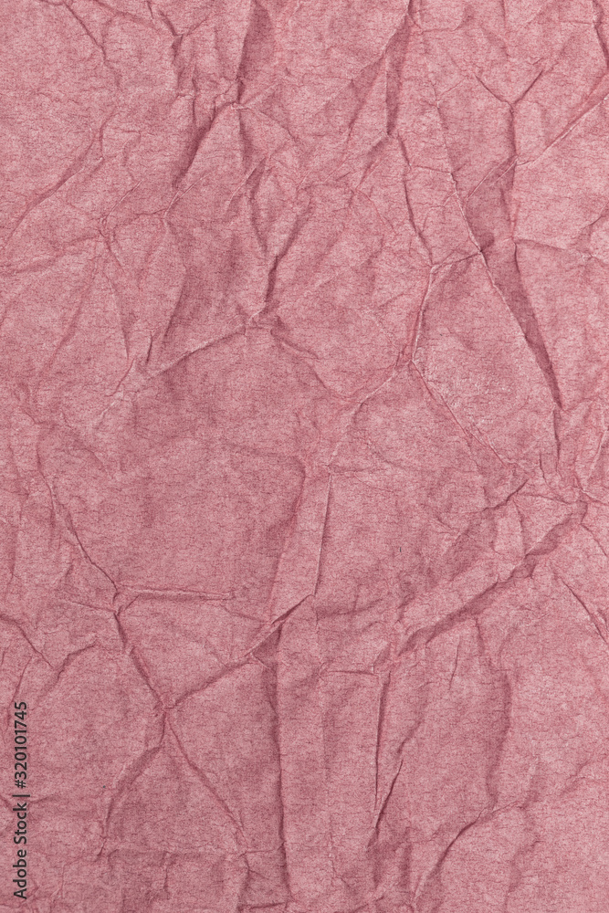 Closeup flatlay vertical photography of pastel pink crumpled paper. Abstract photo background.
