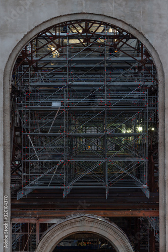 Scaffolding. Restoration. Large stained glass window of an old building
