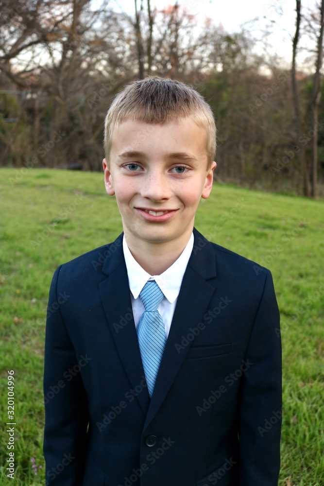 Portrait of a boy coming of age dressed in a sharp suit Portrait of a boy coming of age dressed in a sharp suit