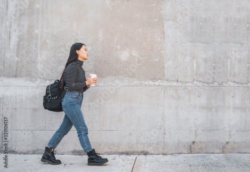 Wallpaper Mural Asian woman walking and holding a cup of coffee. Torontodigital.ca