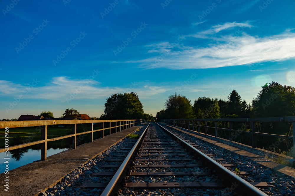 Fototapeta premium Railway line leads through idyllic rural landscape 2