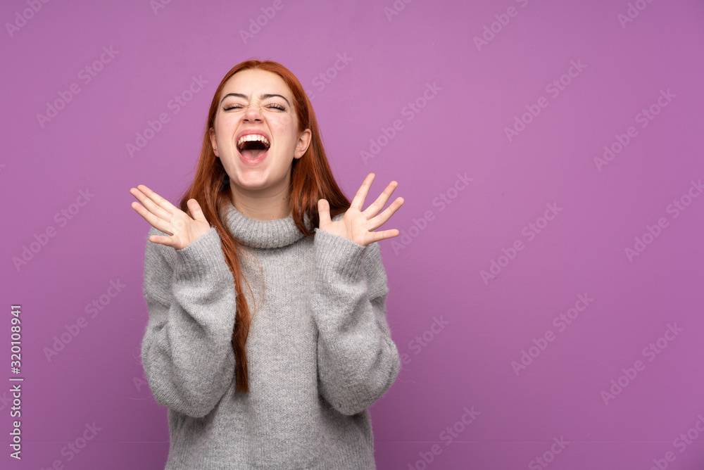 Redhead teenager girl over isolated purple background unhappy and frustrated with something Redhead teenager girl over isolated purple background unhappy and frustrated with something