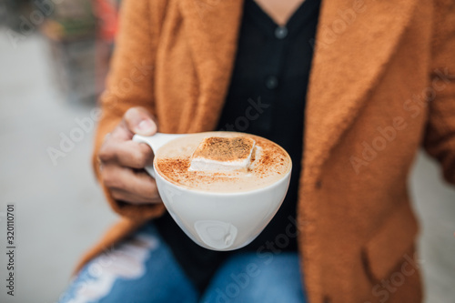 Hand holding fall seasonal latte