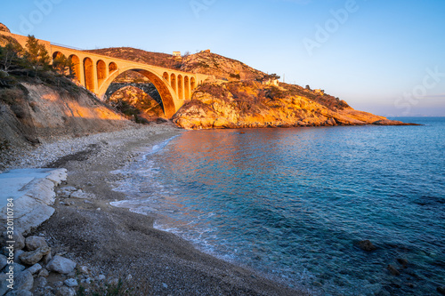 Tableau sur toile Beach and old railway bridge at Carry le Rouet France