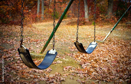 Old swingset at a park in the fall