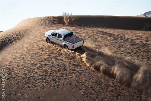 car climbing sand dune photo