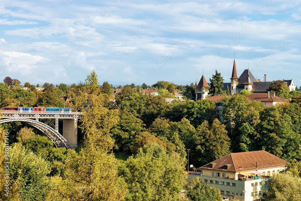 Obraz premium Panorama with Kirchenfeld bridge with running tram and Historical Museum in Bern, Switzerland. Seen from Bundesterrasse