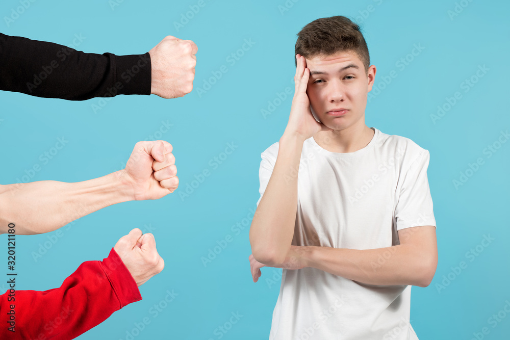concept of a threat from hooligans towards a schoolboy. concept of a threat from hooligans towards a schoolboy.