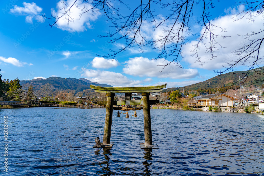 Golden Scale Lake and Yufu Mountain in winter sunny day with clear blue sky. This popular sightseeing spot commonly viewed and photographed by tourist. Yufuin, Oita Prefecture, Japan Golden Scale Lake and Yufu Mountain in winter sunny day with clear blue sky. This popular sightseeing spot commonly viewed and photographed by tourist. Yufuin, Oita Prefecture, Japan