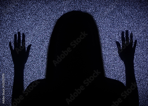 silhouette of a woman without a face on a background of white noise