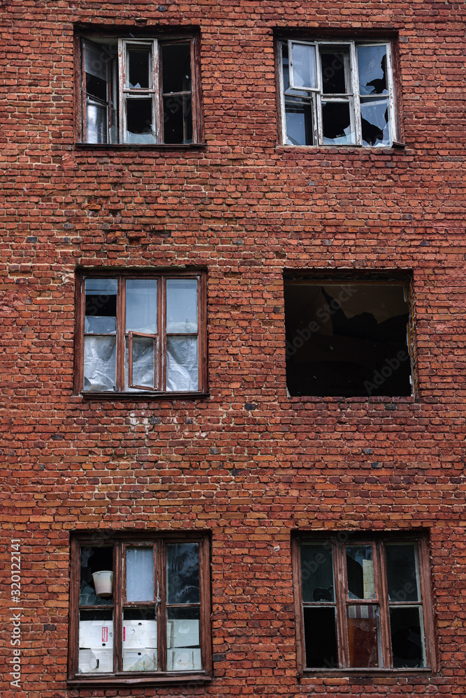 abandoned red brick building with broken windows