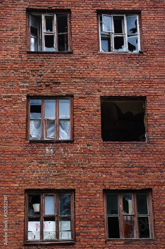 abandoned red brick building with broken windows