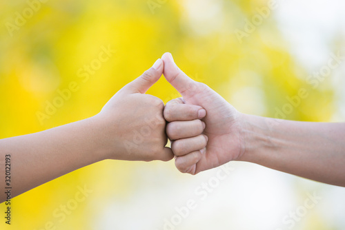 Mother and son made triangles, holding hands naturally, causing the background to blur. Love concept