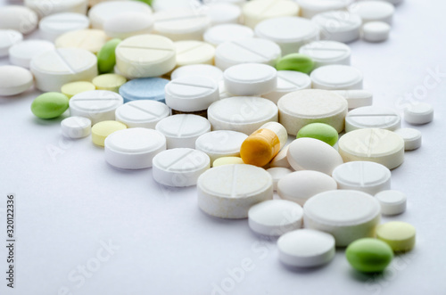 tablets of different shapes and colors on a white background close-up, soft focus