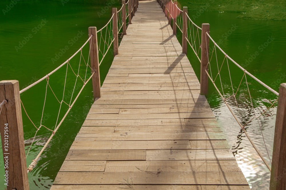wooden suspension bridge over a mountain river wooden suspension bridge over a mountain river