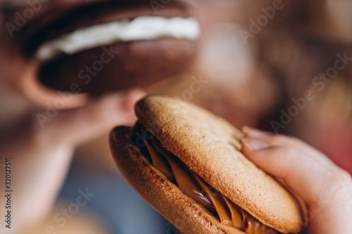 Close up Traditional chocolate and Pumpkin Whoopie pies made with vanilla cream cheese. Background for bakeries, cafes, restaurants photo