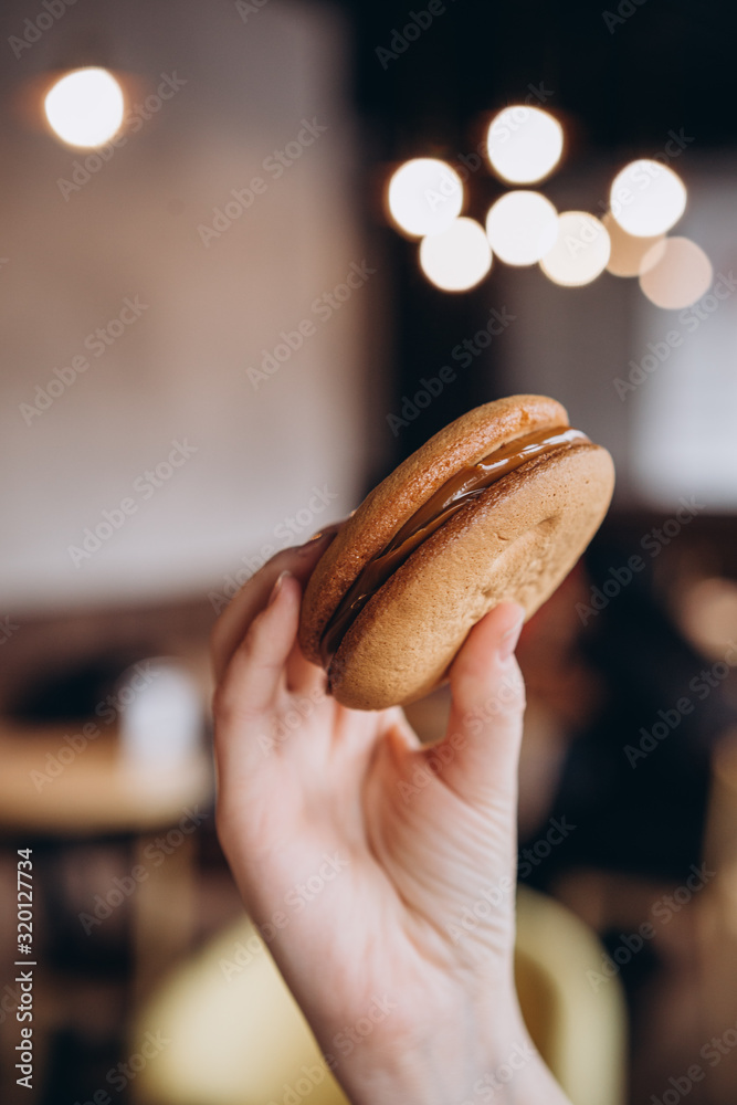 Close up Traditional chocolate and Pumpkin Whoopie pies made with vanilla cream cheese. Background for bakeries, cafes, restaurants Close up Traditional chocolate and Pumpkin Whoopie pies made with vanilla cream cheese. Background for bakeries, cafes, restaurants