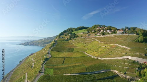 Copter flight through Lavaux vineyars at Lake Geneva shoreline in Switzerland. Lake Geneva at background photo