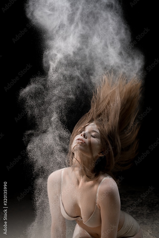 Sexy girl in underwear in white dust cloud