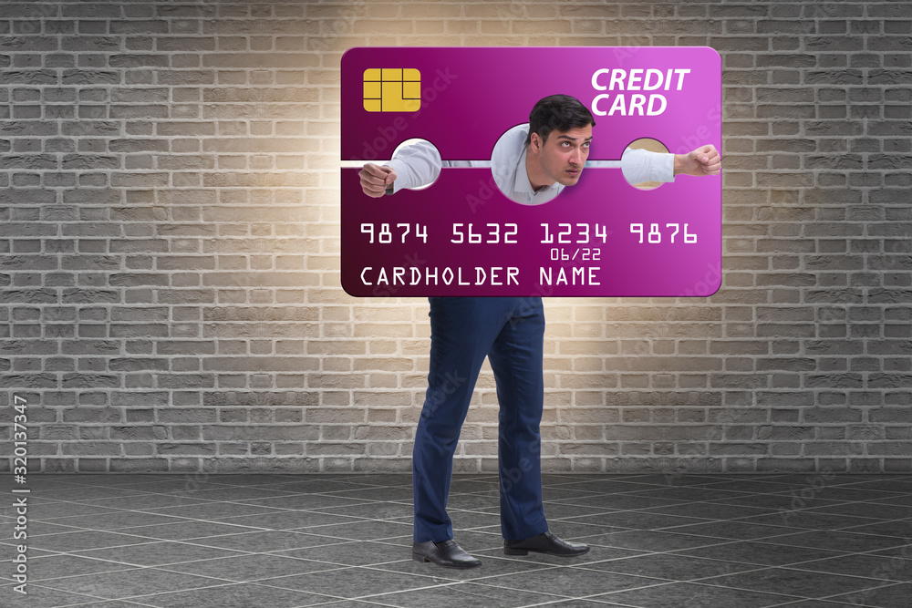 Businessman in credit card burden concept in pillory
