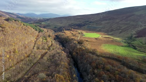 Autumn Highland valley river road and railway 4K aerial drone footage in Scotland, UK photo