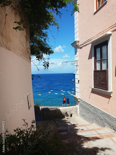 houses sea blue water beach panorama view with tourist in capri island italy summer vacation