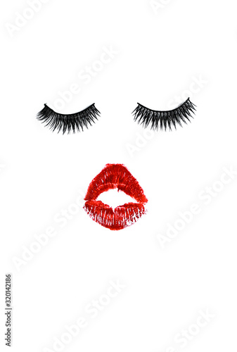 red lips and false eyelashes on a white background