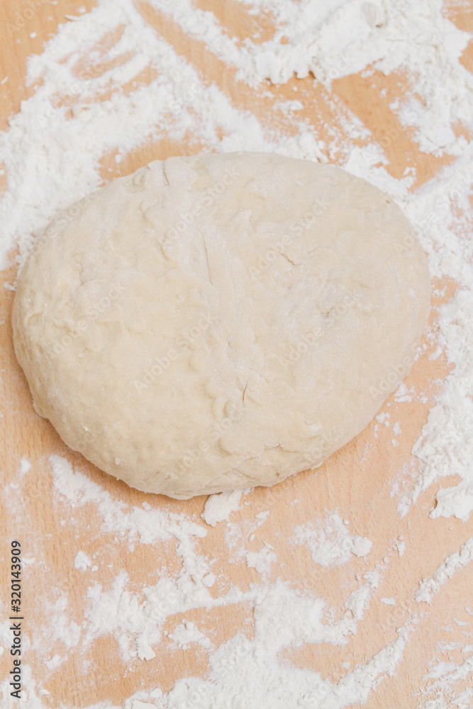 Prepared kneaded dough on a wooden table at home Prepared kneaded dough on a wooden table at home