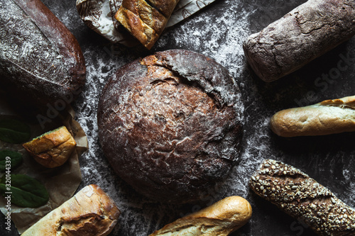 Different types of bread on black background