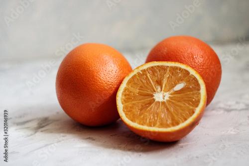 cut orange with a bone on a light background