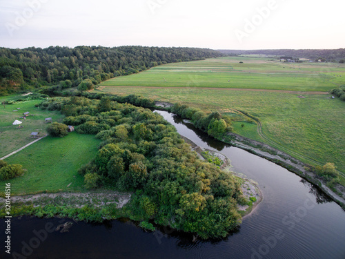 A beautiful sunny view of the forest, fields and river from above. Summer drone photography © boumenjapet