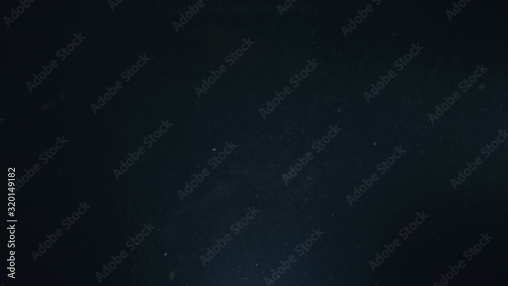A professional dry microfiber rag for washing a car is dipped in water. Bottom view from under the water. Underwater view of towel in hand in black glove. The tissue in fluid air bubbles and flows. A professional dry microfiber rag for washing a car is dipped in water. Bottom view from under the water. Underwater view of towel in hand in black glove. The tissue in fluid air bubbles and flows.