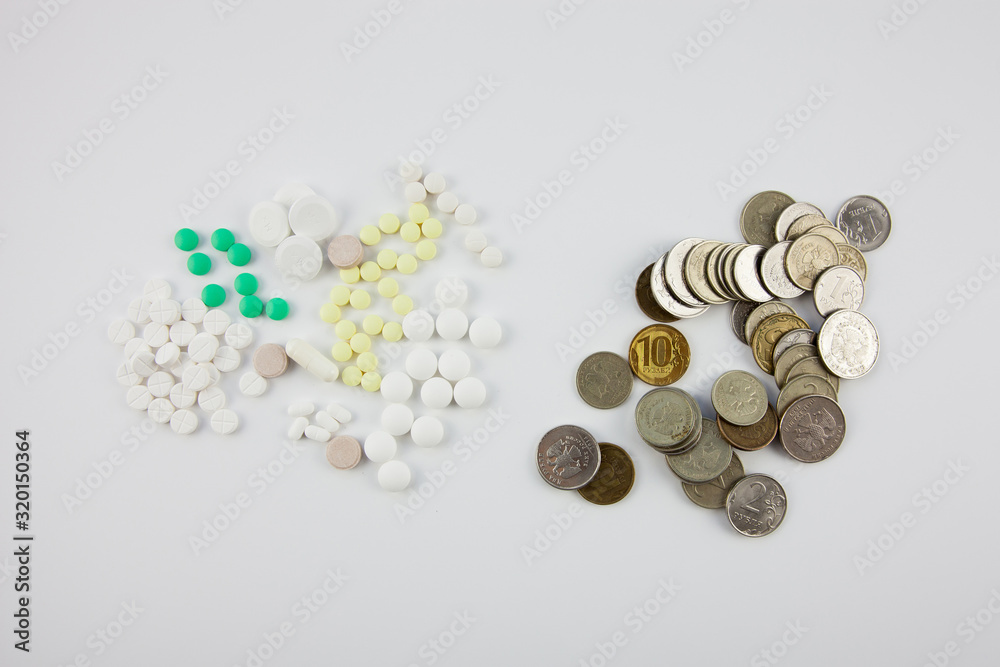 Multi colored pills and money Multi colored pills and money