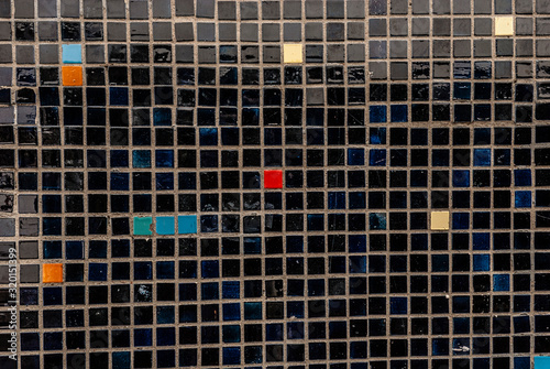 Mosaic of red, yellow, blue and black elements.