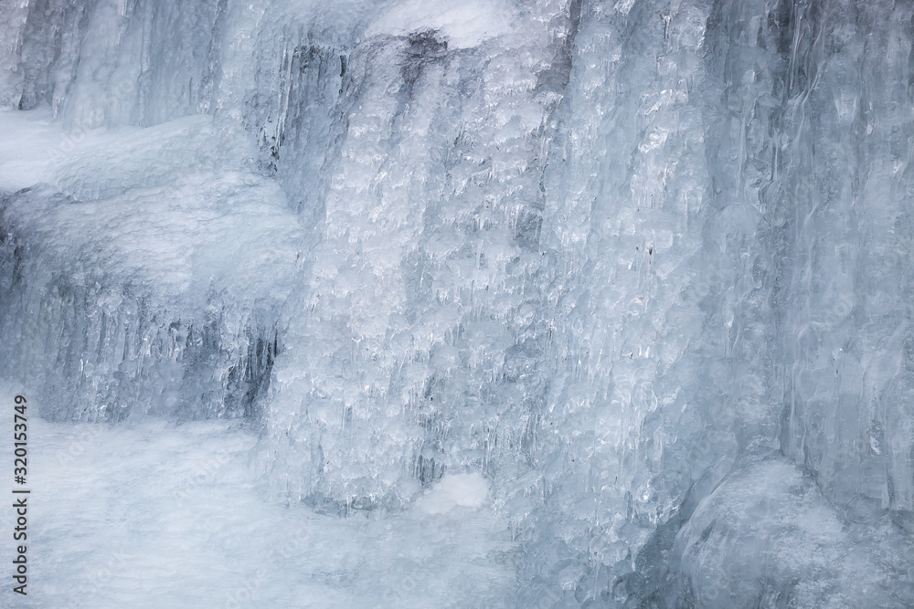 Beautiful, abstract, artistic close-up view of icicles and ice formations of frozen Tupavica waterfall on Old mountain (Stara planina) during winter