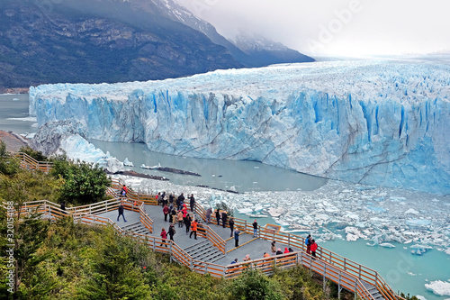 Panoramic view of Perito Moreno Glacier, in El Calafate, Argentina, against a grey and cloudy sky. photo