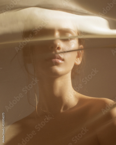  Oriental portrait in the rays of the setting sun through the veil