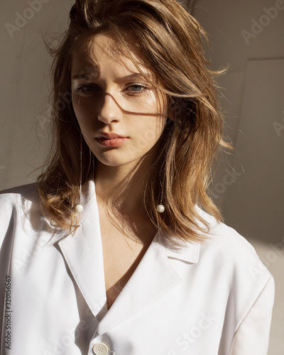  Portrait of a girl with an earring in the sun