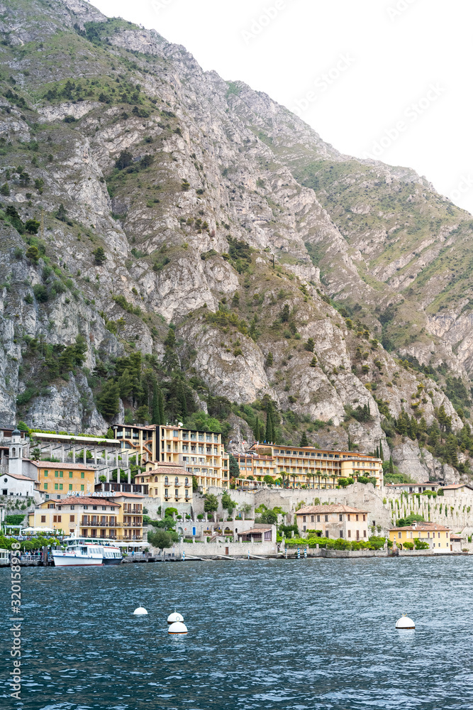 Limone sul Garda, ltaly  - May 21, 2015:.View from a tourist boat on Lake Garda to the coast line with a lot of houses and mountains