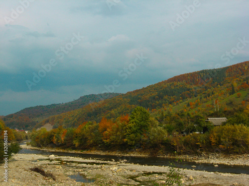 Beautiful views of the mountain river in the autumn. All the colors of the golden autumn.