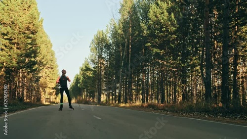 Wallpaper Mural Training an athlete on the roller skaters. Biathlon ride on the roller skis with ski poles, in the helmet. Autumn workout. Roller sport. Adult man riding on skates. Shooting an athlete in motion Torontodigital.ca