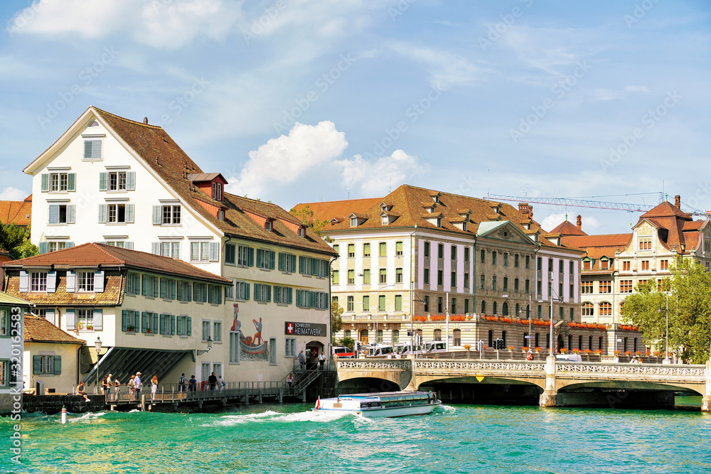 Zurich, Switzerland - September 2, 2016: Old Buildings at Limmat Quay in Zurich, Switzerland. People on the background