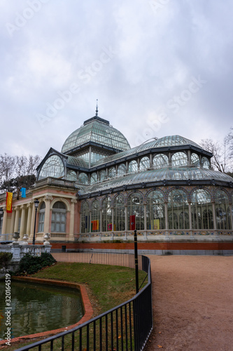 Retiro Park, view of the Crystal Palace. Cloudy day, sunrise. Madrid, travel concept.