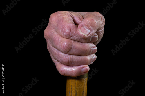 Canvastavla Aging hand holding on to a cane for support.