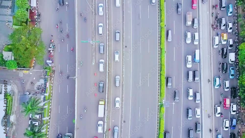 JAKARTA, Indonesia - January 27, 2020: Top down view of tollway with cars on slow and fast line during rush hour